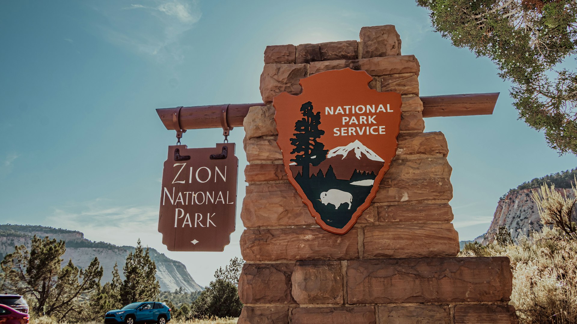 Zion National Park entrance sign with the National Park Service arrowhead